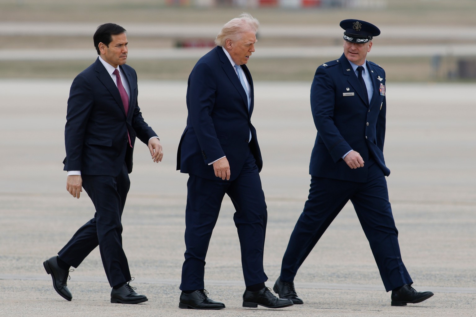 President Donald Trump, accompanied by Secretary of State Marco Rubio and Air Force Col. Christopher M. Robinson, Commander, 89th Airlift Wing, walks from Marine One to Air Force One at Joint Base And ...