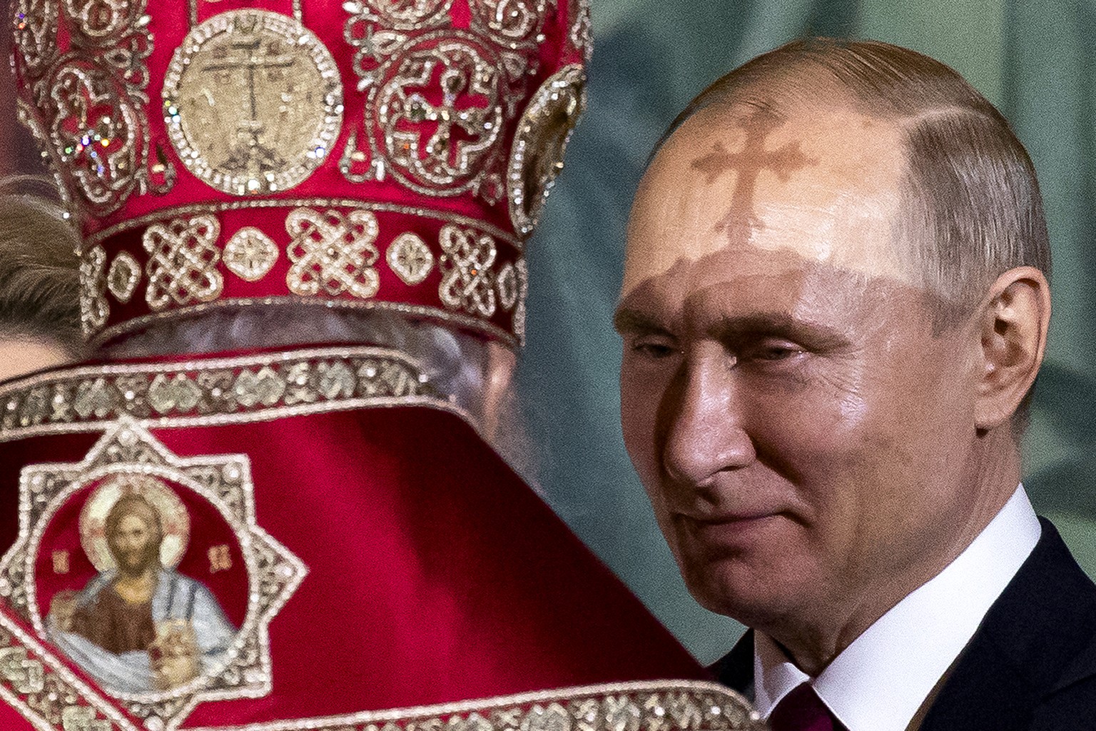 FILE - Russian Orthodox Patriarch Kirill, left, talks to President Vladimir Putin, right, during the Easter service in the Christ the Savior Cathedral in Moscow, Russia, on April 28, 2019. Putin, who  ...