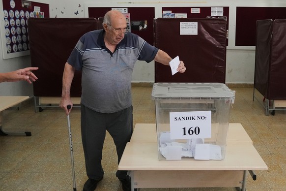 A man casts his ballot at a polling station during the Turkish Cypriot leadership election in the Turkish-occupied northern part of the divided capital Nicosia, Cyprus, Sunday, Oct. 19, 2025. (AP Phot ...
