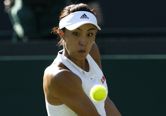 China&#039;s Qiang Wang returns to Venus Williams of the United States during their Women&#039;s Singles Match on day three at the Wimbledon Tennis Championships in London Wednesday, July 5, 2017. (AP ...