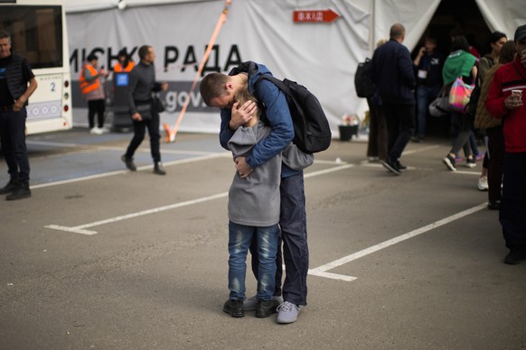 Andrii Fedorov hugs his son Makar as they reunited at a reception center for displaced people in Zaporizhzhia, Ukraine, Monday, May 2, 2022. Makar and his mother Dariia Fedora fled from Mariupol as th ...