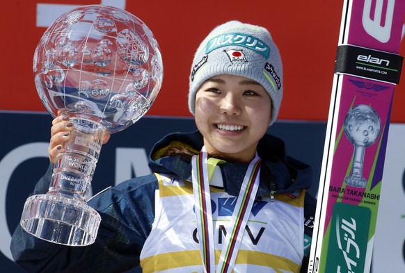 Sara Takanashi from Japan celebrates her overall World Cup title during the award ceremony following the Ski Jumping World Cup mens event in Planica, Slovenia, Sunday, March 20, 2016. (AP Photo/Darko  ...