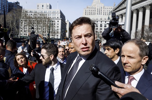 epa07485645 Tesla CEO Elon Musk (C) answers a reporter&#039;s question following a hearing in a lawsuit brought against him by the United States Security and Exchange Commission (SEC) at US Federal Co ...