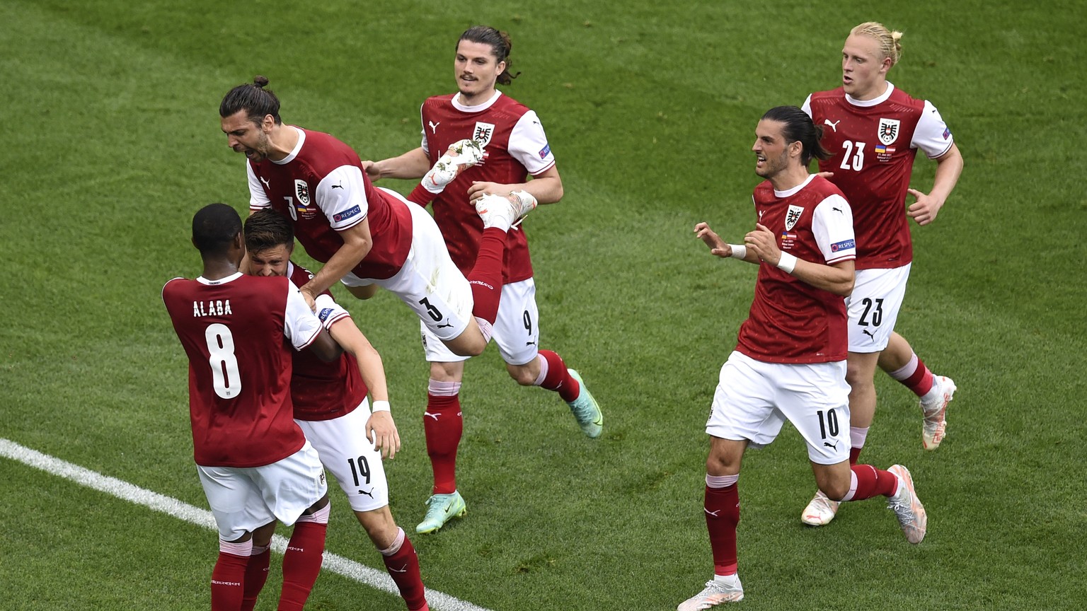 Austria&#039;s Christoph Baumgartner celebrates with teammates after scoring his sides first goal during the Euro 2020 soccer championship group C match between Ukraine and Austria at the National Are ...