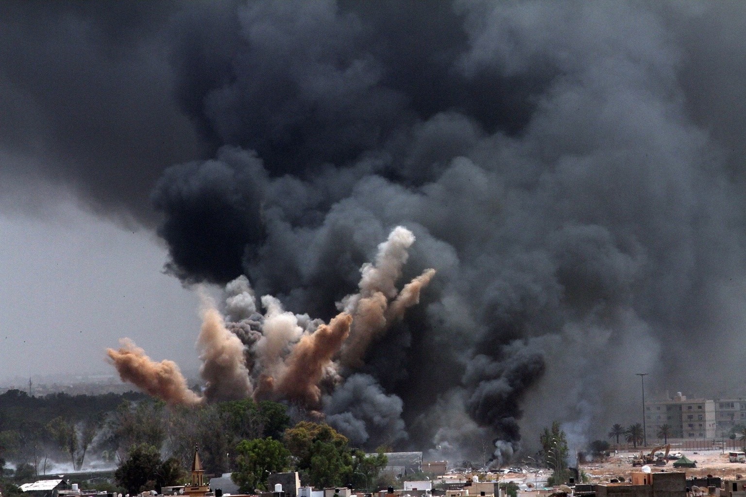 epa12594294 (FILE) - Smoke rises in the sky after a NATO air strike in Tripoli, Libya, 07 June 2011 (reissued 15 December 2025). The Arab Spring was a wave of anti-government protests and pro-democrac ...
