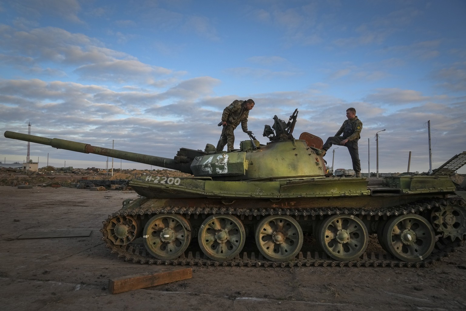 Ukrainian soldiers inspect a damaged Russian tank in the recently retaken village Chornobaivka near Kherson, Ukraine, Tuesday, Nov. 15, 2022. (AP Photo/Efrem Lukatsky)