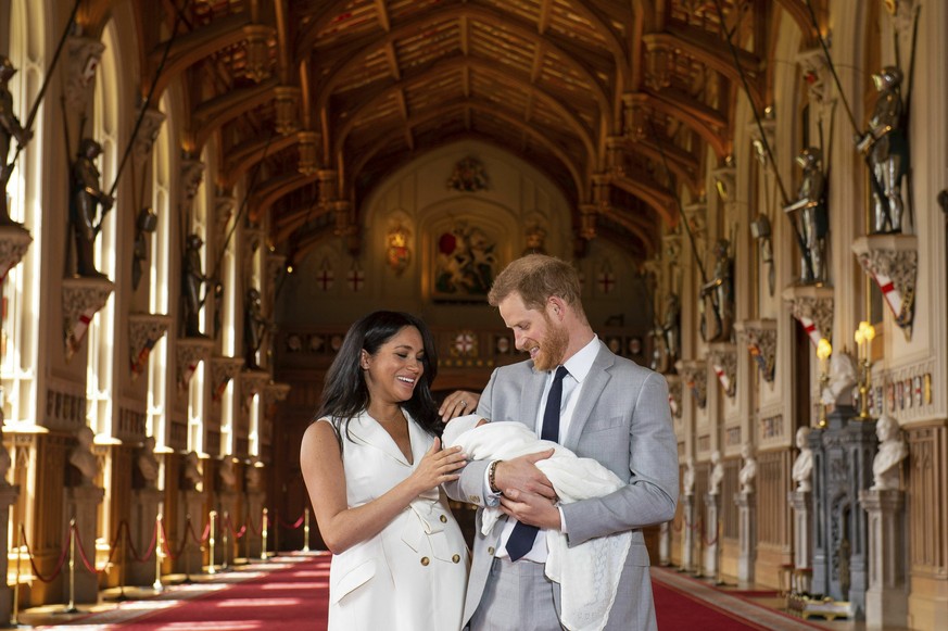 Britain&#039;s Prince Harry and Meghan, Duchess of Sussex, during a photocall with their newborn son, in St George&#039;s Hall at Windsor Castle, Windsor, south England, Wednesday May 8, 2019. Baby Su ...