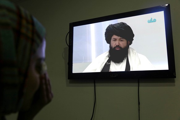 epa10376714 An Afghan girl watches the speech of Taliban higher education minister Nida Muhammad Nadeem on a television in Kabul, Afghanistan, December 22, 2022. Nida Muhammad said in a television…