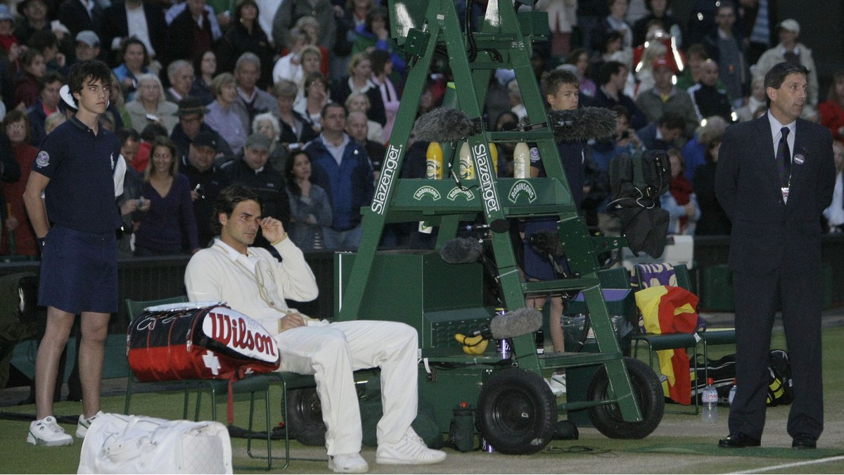 Switzerland's Roger Federer sits in his courtside chair following his five set loss to Spain's Rafael Nadal in the men's singles final on the Centre Court at Wimbledon, Sunday, July 6,  ...