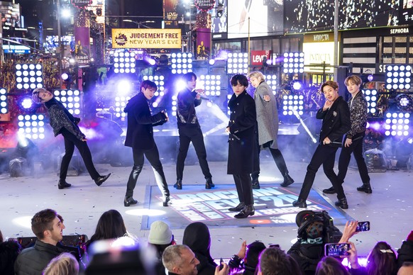 FILE - Members of BTS perform at the Times Square New Year&#039;s Eve celebration in New York on Dec. 31, 2019. The K-pop band is nominated for a Grammy Award for best pop duo/group performance with � ...