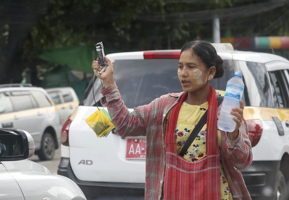 epa12274692 A woman sells cigarettes, betel nuts, and drinking water in Yangon, Myanmar, 31 July 2025. EPA/NYEIN CHAN NAING