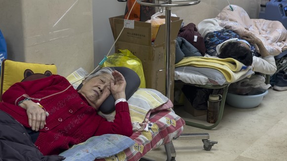 Elderly patients rest along an emergency department corridor while receiving intravenous infusions in Beijing, Thursday, January 5, 2023. Patients, most of them elderly, lie on stretchers in corridors a…