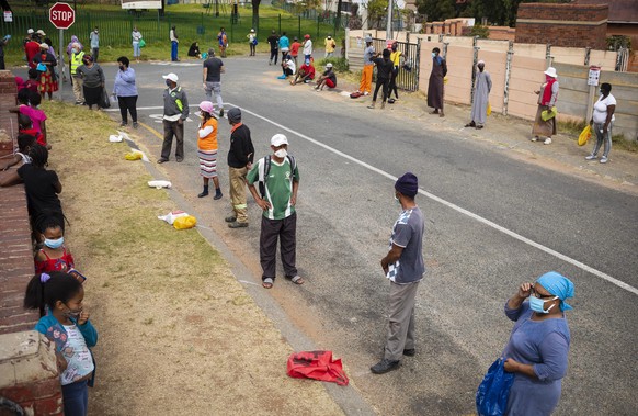 epa08431766 Local residents line up patiently during a food handout by &#039;Hunger has no religion group&#039; in Carination on day 53 of the national lockdown as a result of Covid-19 Coronavirus, in ...