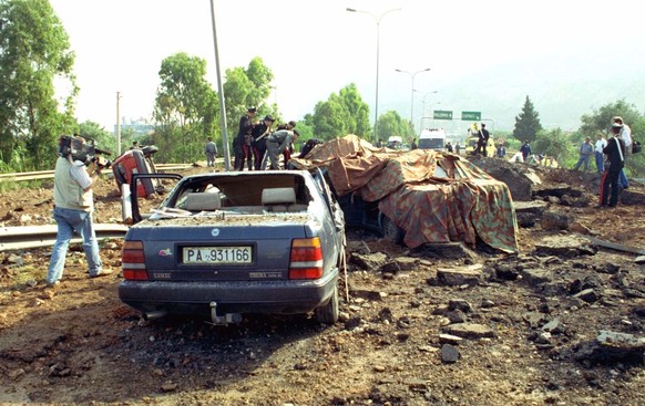 FILE - This May 23, 1992 file photo shows the damage at a highway that links Palermo to its airport after a bomb blast killed anti-Mafia prosecutor Giovanni Falcone, his wife and three policemen escor ...