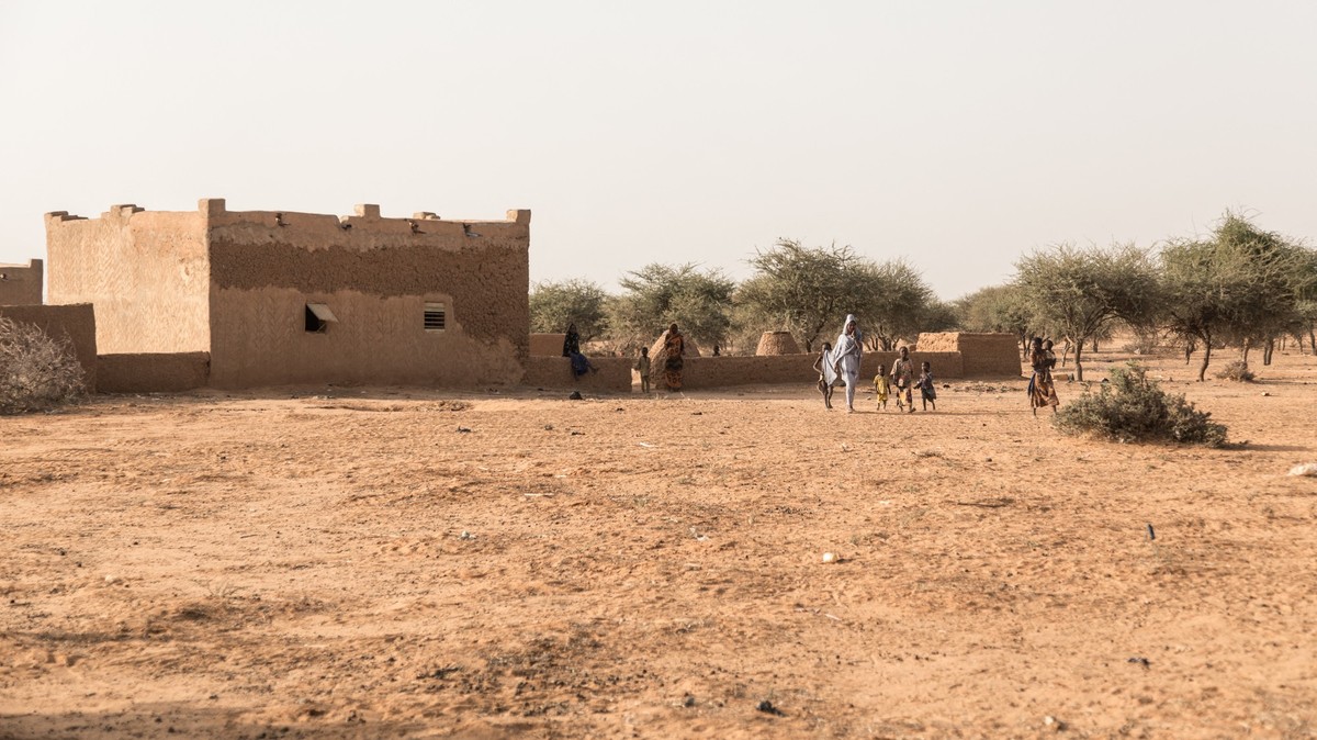 A Malian family walks in a village near Menaka, Mali, on October 28, 2021. (Photo by FLORENT VERGNES / AFP)