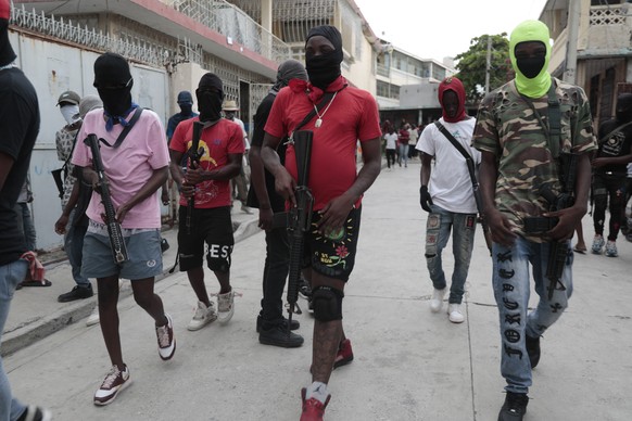Armed members of &quot;G9 and Family&quot; march in a protest against Haitian Prime Minister Ariel Henry in Port-au-Prince, Haiti, Tuesday, Sept. 19, 2023. (AP Photo/Odelyn Joseph)