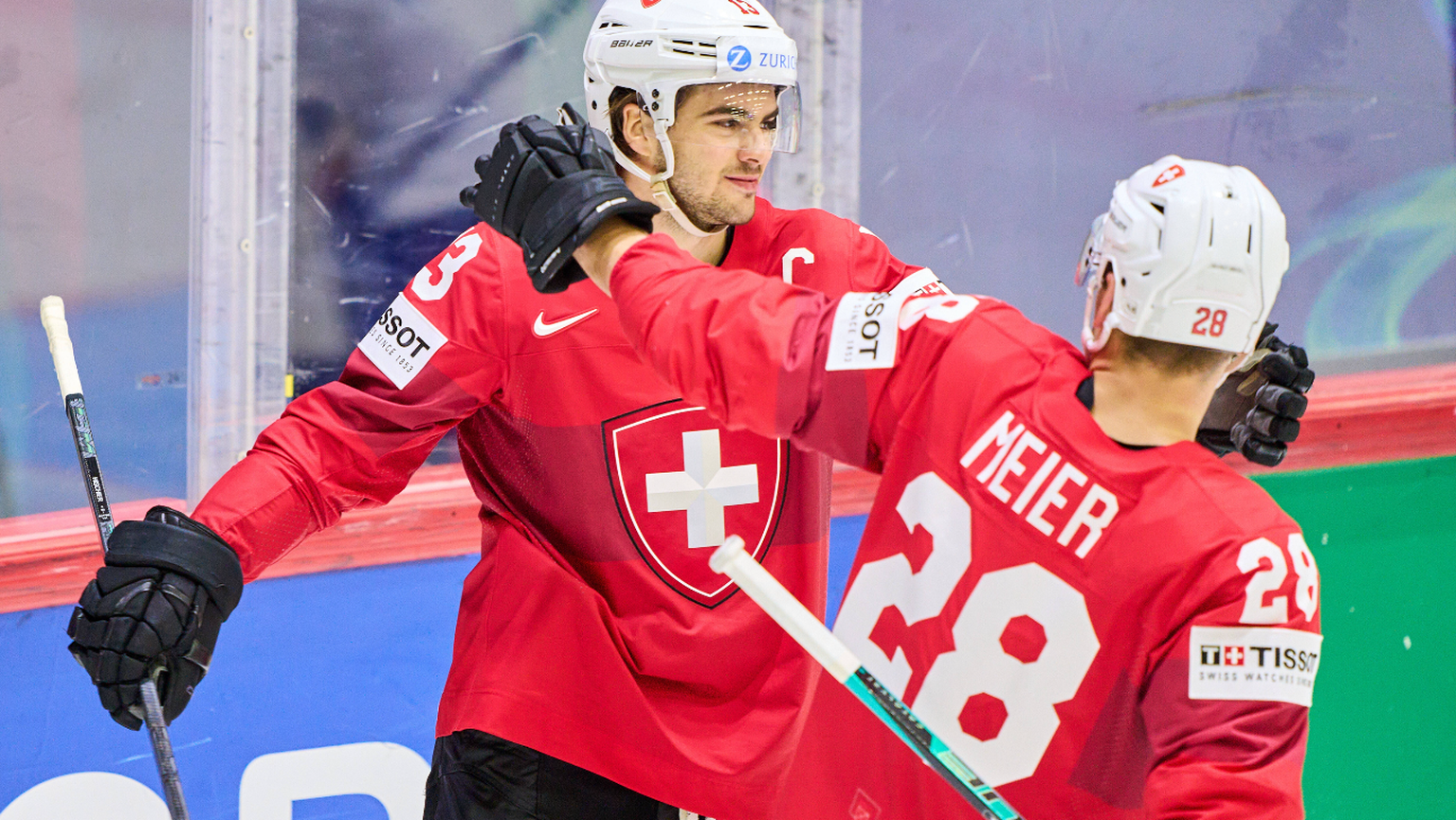 Nico Hischier Nr. 13 of Switzerland scores, shoots goal , Tor, Treffer, Torschuss, 4-2 celebrates his goal, happy, laugh, celebration, with Timo Meier Nr. 28 of Switzerland in the match SWITZERLAND -  ...