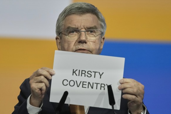 IOC President Thomas Bach holds up the name of Kirsty Coventry as she is announced as the new IOC President at the International Olympic Committee 144th session in Costa Navarino, western Greece, Thur ...