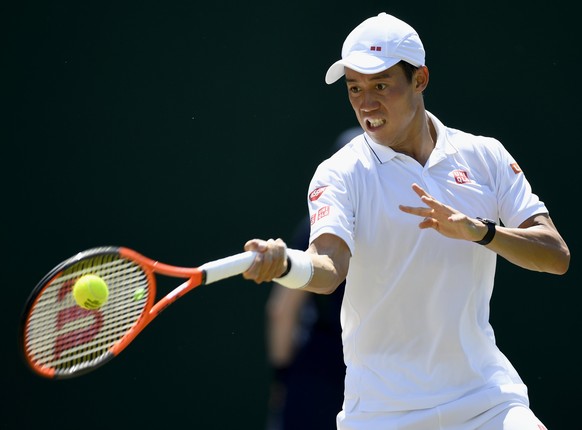 epa06072983 Kei Nishikori of Japan in action against Roberto Bautista Agut of Spain during their third round match for the Wimbledon Championships at the All England Lawn Tennis Club, in London, Brita ...