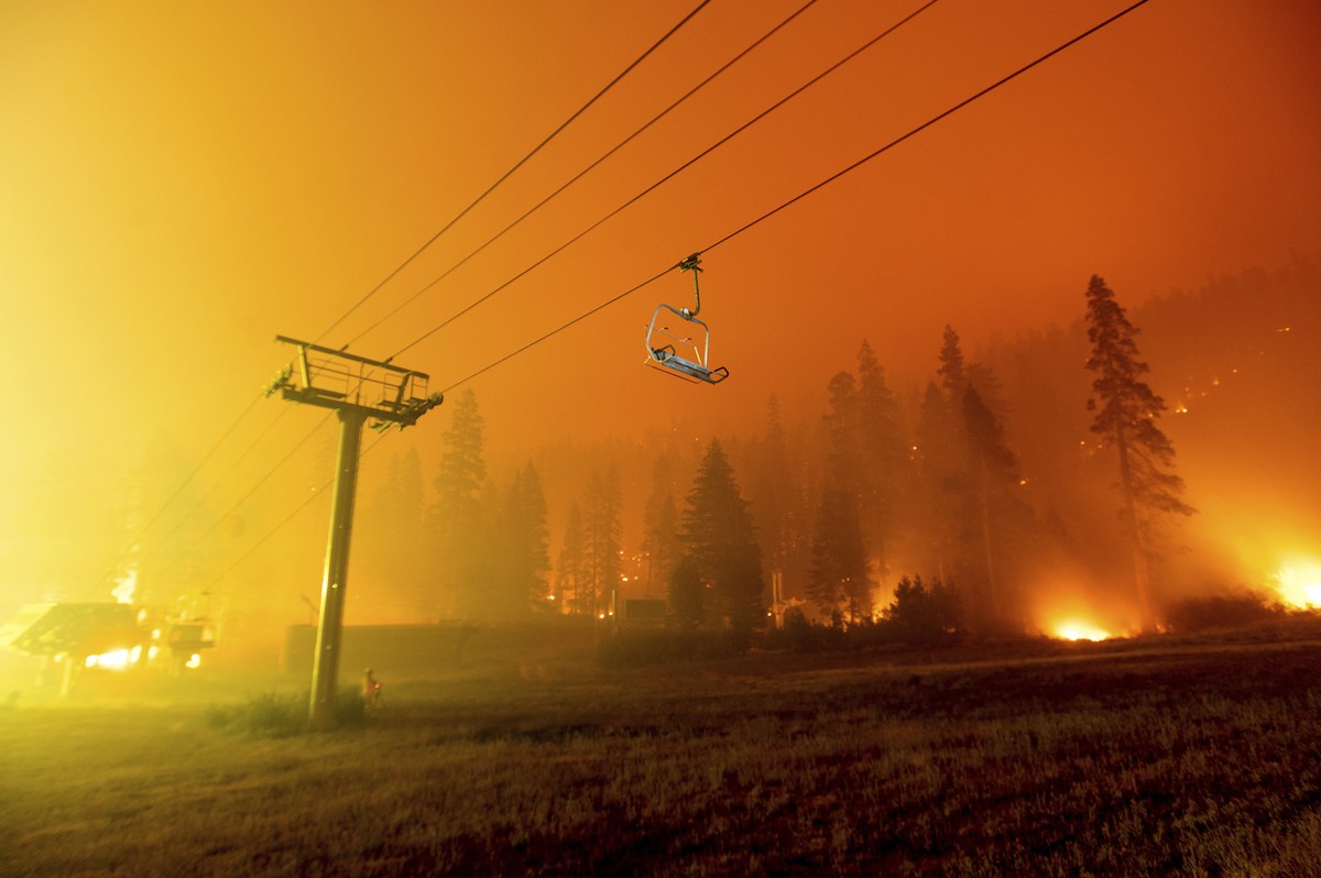 Seen in a long camera exposure, the Caldor Fire burns at the Sierra-at-Tahoe ski resort on Sunday, Aug. 29, 2021, in Eldorado National Forest, Calif. The main buildings at the ski slope's base su ...