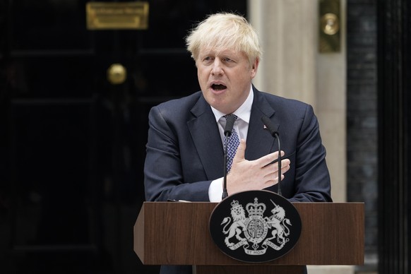 British Prime Minister Boris Johnson speaks to media next to 10 Downing Street in London, Thursday, July 7, 2022. Prime Minister Boris Johnson has agreed to resign, his office said Thursday, ending an ...