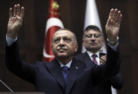 Turkish President Recep Tayyip Erdogan gestures as he addresses his ruling party legislators at the Parliament, in Ankara, Wednesday, Oct 16, 2019. Erdogan called Wednesday on Syrian Kurdish fighters  ...