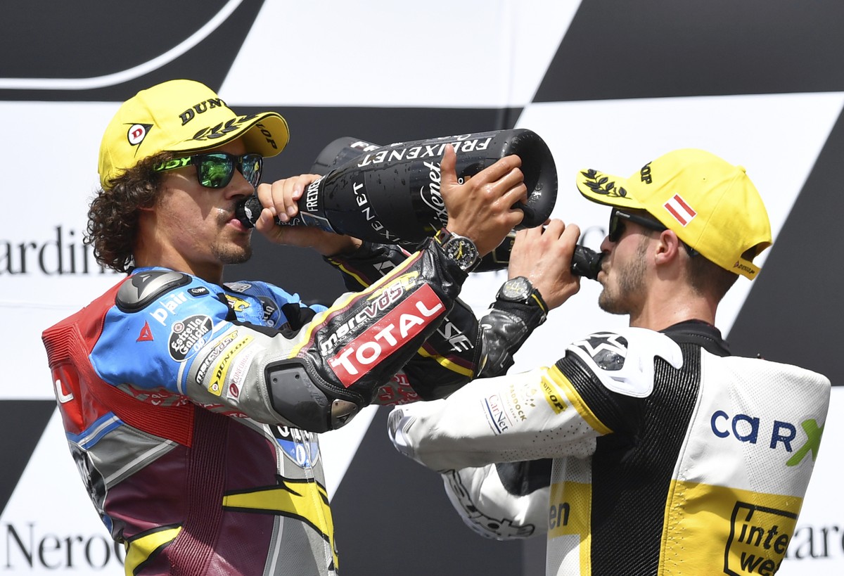 Third placed Switzerland's Thomas Luthi of the CarXpert Interwetten, right, and Moto2 race winner Italian rider Franco Morbidelli of the EG 0,0 Marc VDS team celebrate at the Moto2 race at the Au ...