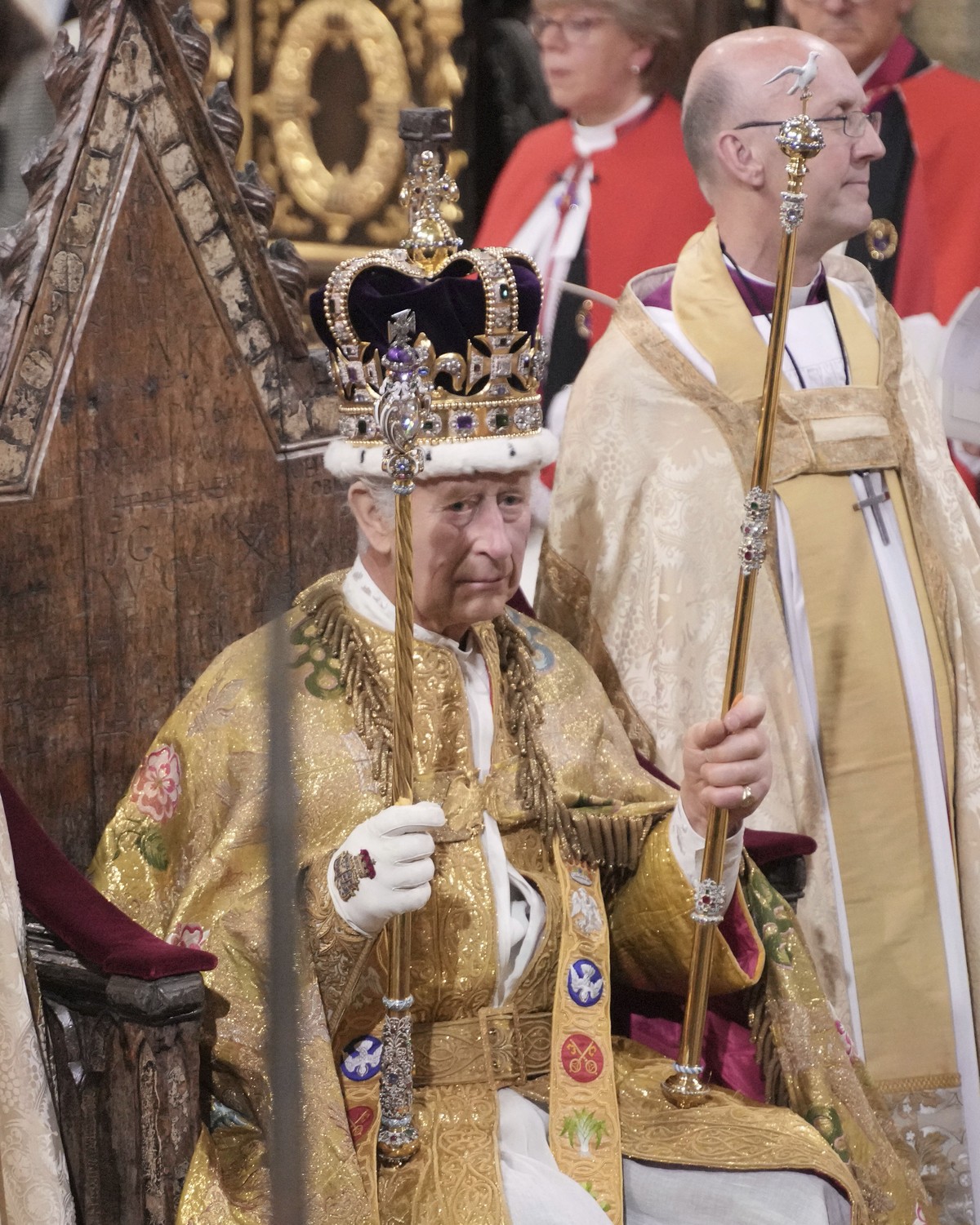 King Charles III holds holds The Sovereign's Sceptre with Cross after he was crowned with St Edward's Crown during the coronation ceremony at Westminster Abbey, London, Saturday, May 6, 2023 ...