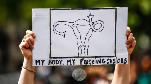 epa10035407 A woman holds a placard during an abortion rights protest following the decision by the US Supreme Court to overturn the Roe v. Wade ruling, in Place de la Republique, Paris, France, 26 Ju ...