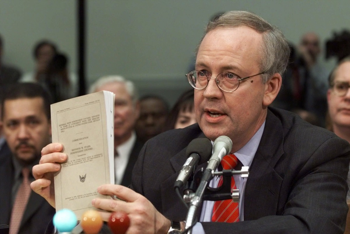 FILE - Independent Counsel Kenneth Starr holds a copy of his report while testifying on Capitol Hill Thursday Nov. 19, 1998, before the House Judiciary Committee's impeachment hearing. Starr, who ...