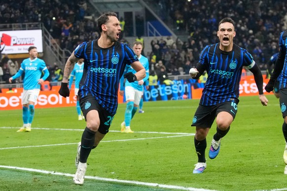 Inter Milan's Hakan Calhanoglu, centre left, celebrates with Lautaro Martinez after scoring his side's second goal during the Serie A soccer match between Inter Milan and Napoli in Milan, It ...