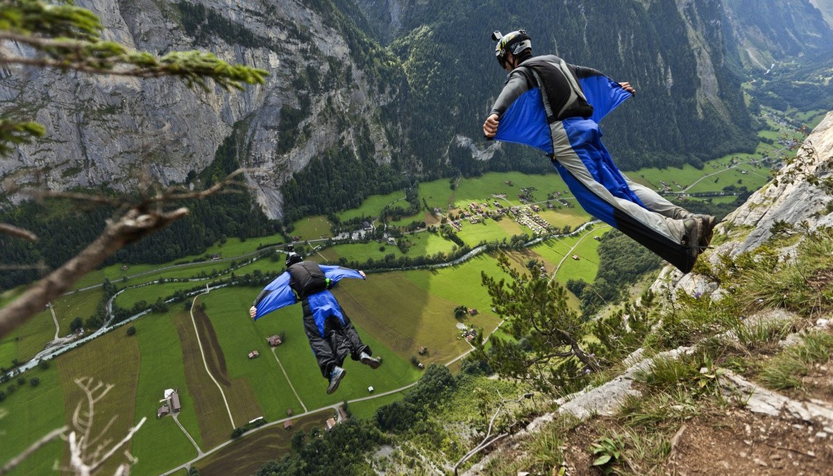 Two basejumpers fall after leaping from the exit point High Nose (550 meters) in the valley of Lauterbrunnen, pictured on august 14, 2011. Since they are wearing wingsuits, their free-fall-time is ext ...