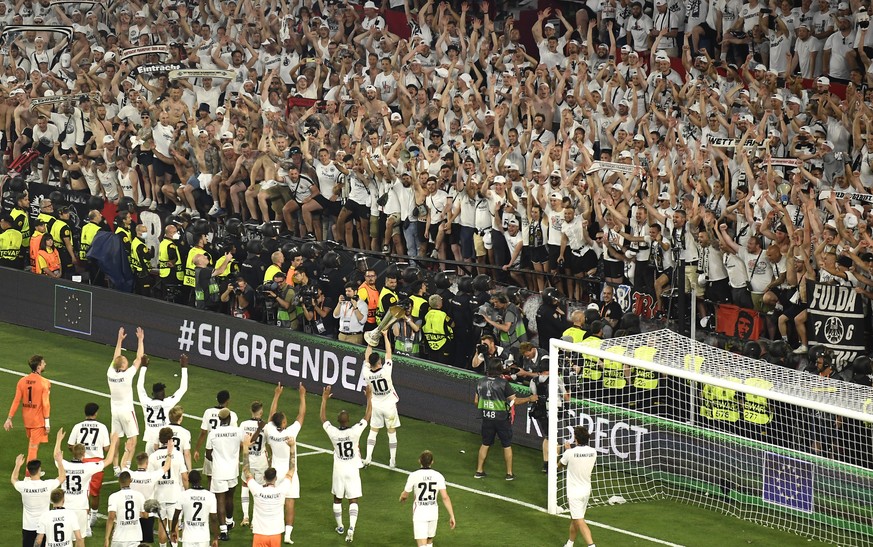 Frankfurt players celebrate with the trophy after winning the Europa League final soccer match between Eintracht Frankfurt and Rangers FC at the Ramon Sanchez Pizjuan stadium in Seville, Spain, Thursd ...