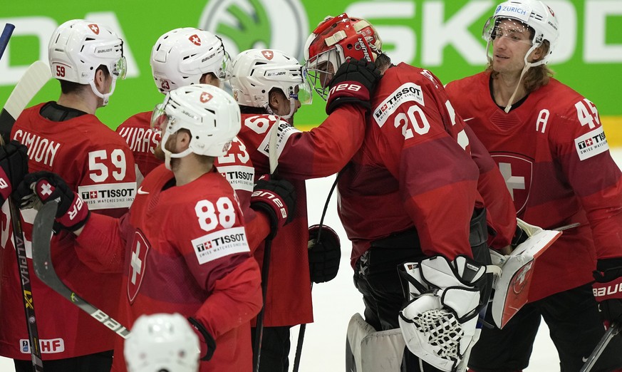 Switzerland&#039;s keeper Reto Berra is celebrated by the team after winning the penalty shootout of the group A Hockey World Championship match between Germany and Switzerland in Helsinki, Finland, T ...