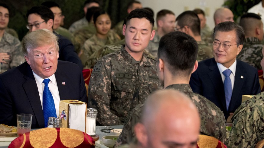 U.S. President Donald Trump and South Korean President Moon Jae-in, right, have lunch with U.S. and South Korean troops at Camp Humphreys in Pyeongtaek, South Korea, Tuesday, Nov. 7, 2017. Trump is on ...