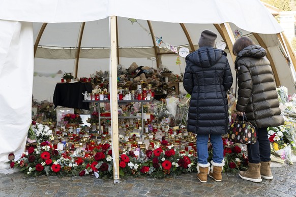 Flowers and candles are pictured in tribute to the victims after the fire at the "Le Constellation" bar and lounge, in Crans-Montana, Switzerland, Wednesday, January 14, 2026. 40 people most ...