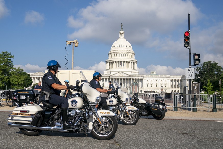epa10031775 US Capitol Police motor officers on patrol as activists protest outside the Supreme Court in Washington, DC, USA, 24 June 2022. Protests continue as activists outside the court wait for th ...