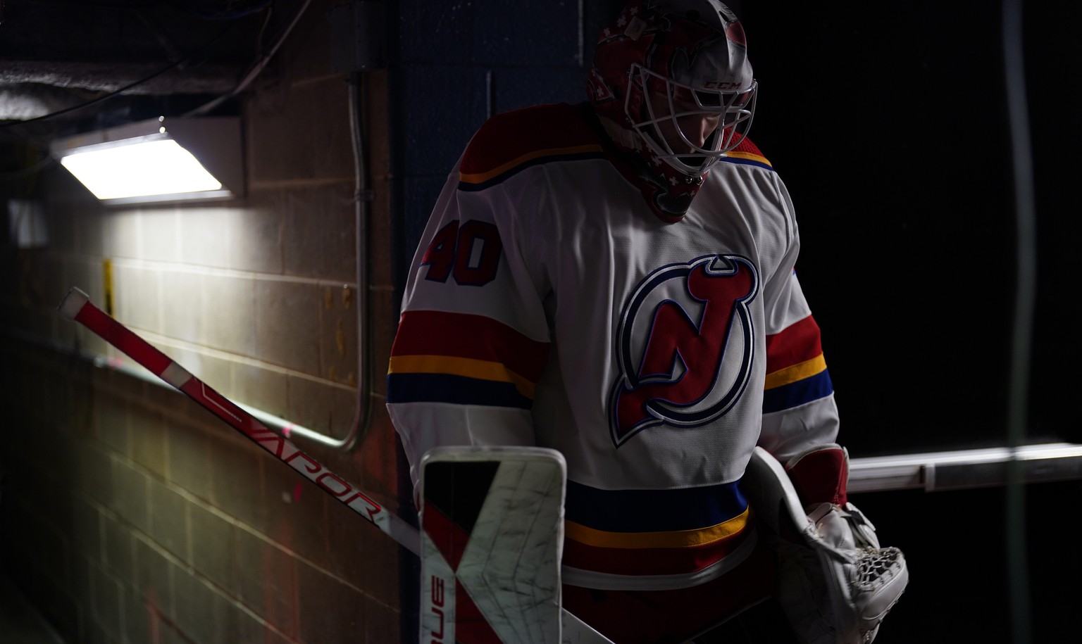 New Jersey Devils&#039; Akira Schmid waits to warm up before an NHL hockey game against the Philadelphia Flyers, Saturday, Dec. 3, 2022, in Philadelphia. (AP Photo/Matt Slocum)