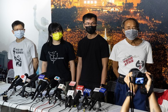 epa09454469 The vice-chairwoman of The Hong Kong Alliance in Support of Patriotic Democratic Movements in China Chow Hang-tung (2-L) and fellow alliance members Leung Kam-wai (2-R), and Tang Ngok-kwan ...