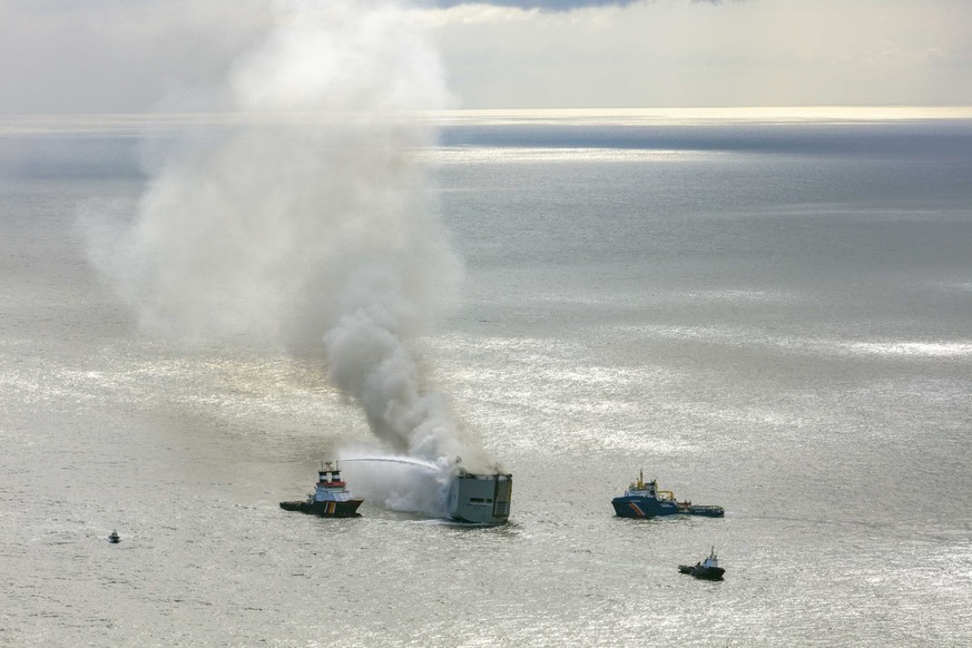 epa10769259 An aerial view shows fire extinguishing operation taking place as smoke rises from the Fremantle Highway cargo ship, in the North Sea, Ameland, the Netherlands, 16 July 202.3 A fire broke  ...