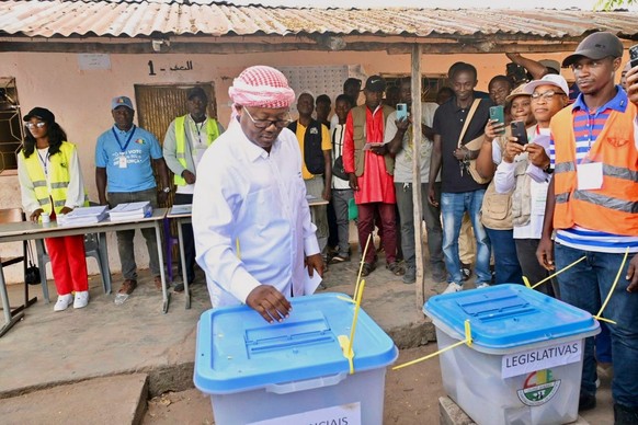 In this photo released by the Communication office Presidency republic of Guinea Bissau, incumbent President Umaro Sissoco Embalo casts his votes at a polling station during the Presidential and legis ...
