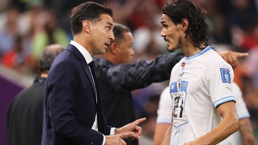 epa10335204 Head coach of Uruguay Diego Alonso gives instructions to Edinson Cavani during the FIFA World Cup 2022 group H soccer match between Portugal and Uruguay at Lusail Stadium in Lusail, Qatar, ...