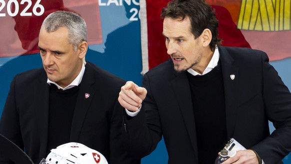 Patrick Fischer, right, head coach of Switzerland national ice hockey team, gestures next to Jan Cadieux, left, assistant coach of Switzerland national ice hockey team, during the men's group A p ...