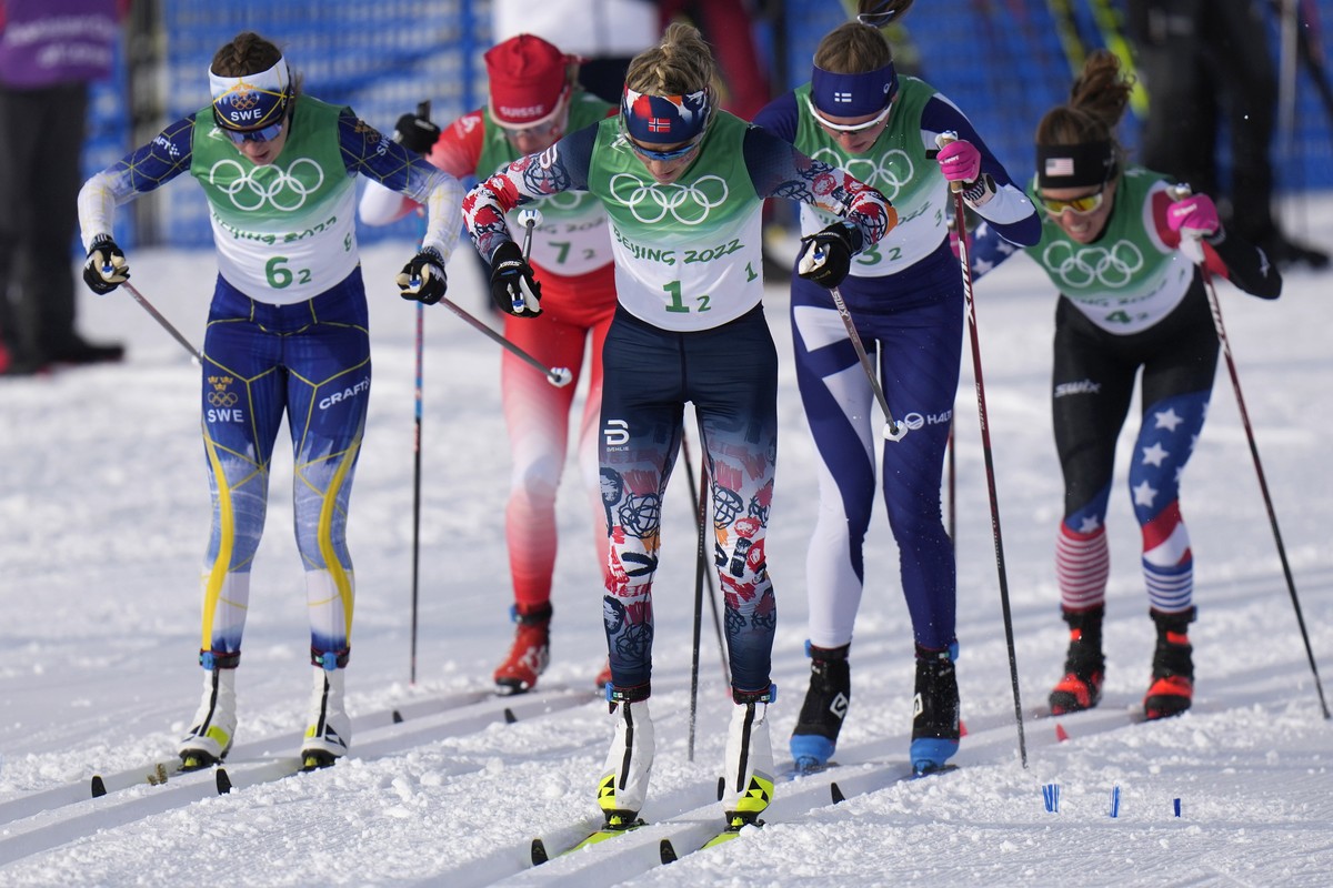 Therese Johaug, of Norway, center, leads a group during the women's 4 x 5km relay cross-country skiing competition at the 2022 Winter Olympics, Saturday, Feb. 12, 2022, in Zhangjiakou, China. (AP ...