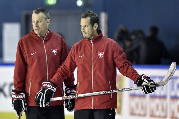 Patrick Fischer, head coach of Switzerland national ice hockey team, right, and his assitant coach Tommy Albelin look on during a training session during the Ice Hockey World Championship at the Accor ...