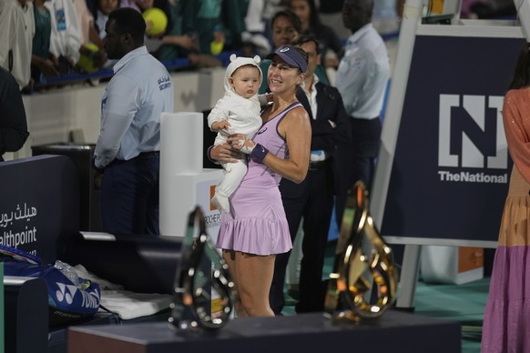 Belinda Bencic of Switzerland holds her daughter during the award ceremony after winning the Women&#039;s single final match of the Mubadala Abu Dhabi Open tennis tournament, in Abu Dhabi, United Arab ...
