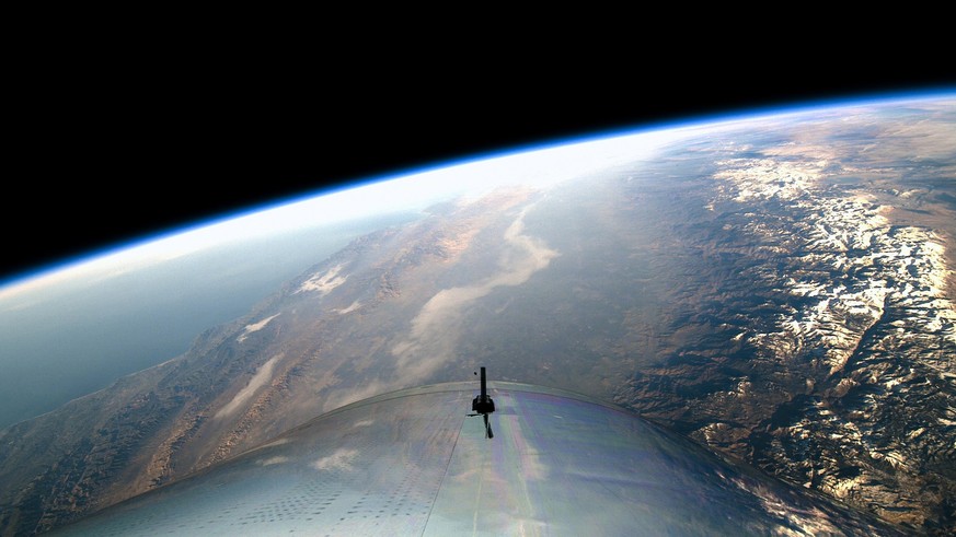 epa07230018 A handout photo made available by Virgin Galactic shows a view from SpaceShipTwo, a rocket plane designed for space tourism, during a test flight in the edge of space, around 51 miles (or  ...