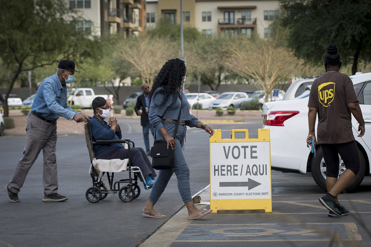 epa08794268 Voters prepare to cast emergency ballots at Burton Barr Library in Phoenix, Arizona, USA, 02 November 2020. Arizonans were permitted to cast emergency if they have health concerns about co ...