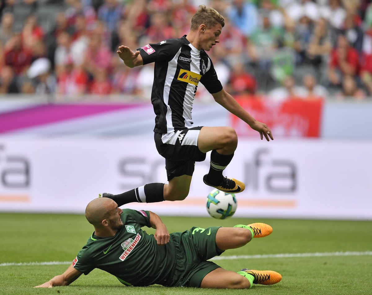 Moenchengladbach's Mickael Cuisance, up, and Bremen's Luca Caldirola challenge for the ball during the Telekom Cup soccer match between Borussia Moenchengladbach and Werder Bremen at the Bor ...