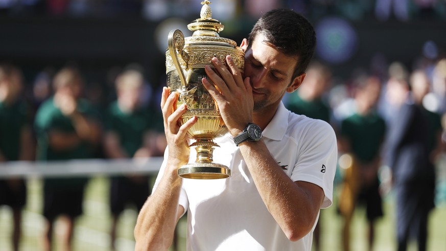 epa06890951 Novak Djokovic of Serbia celebrates after defeating Kevin Anderson of South Africa in the men&#039;s singles final of the Wimbledon Championships at the All England Lawn Tennis Club, in Lo ...